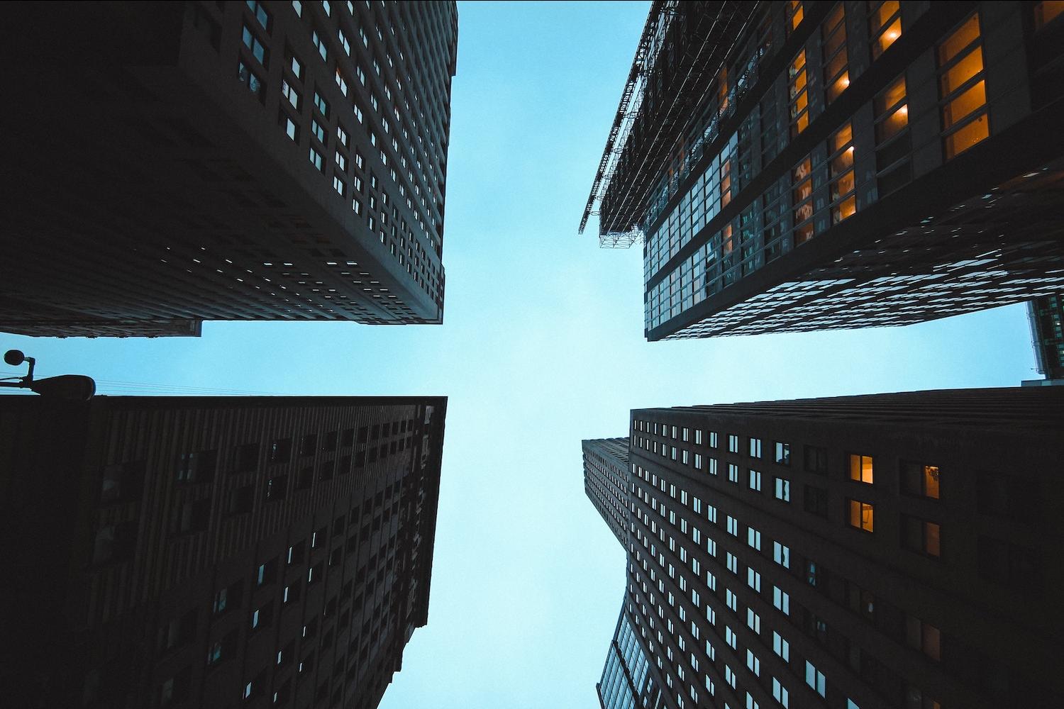 looking up at high rises in the city - ESG matters even during economic downturns